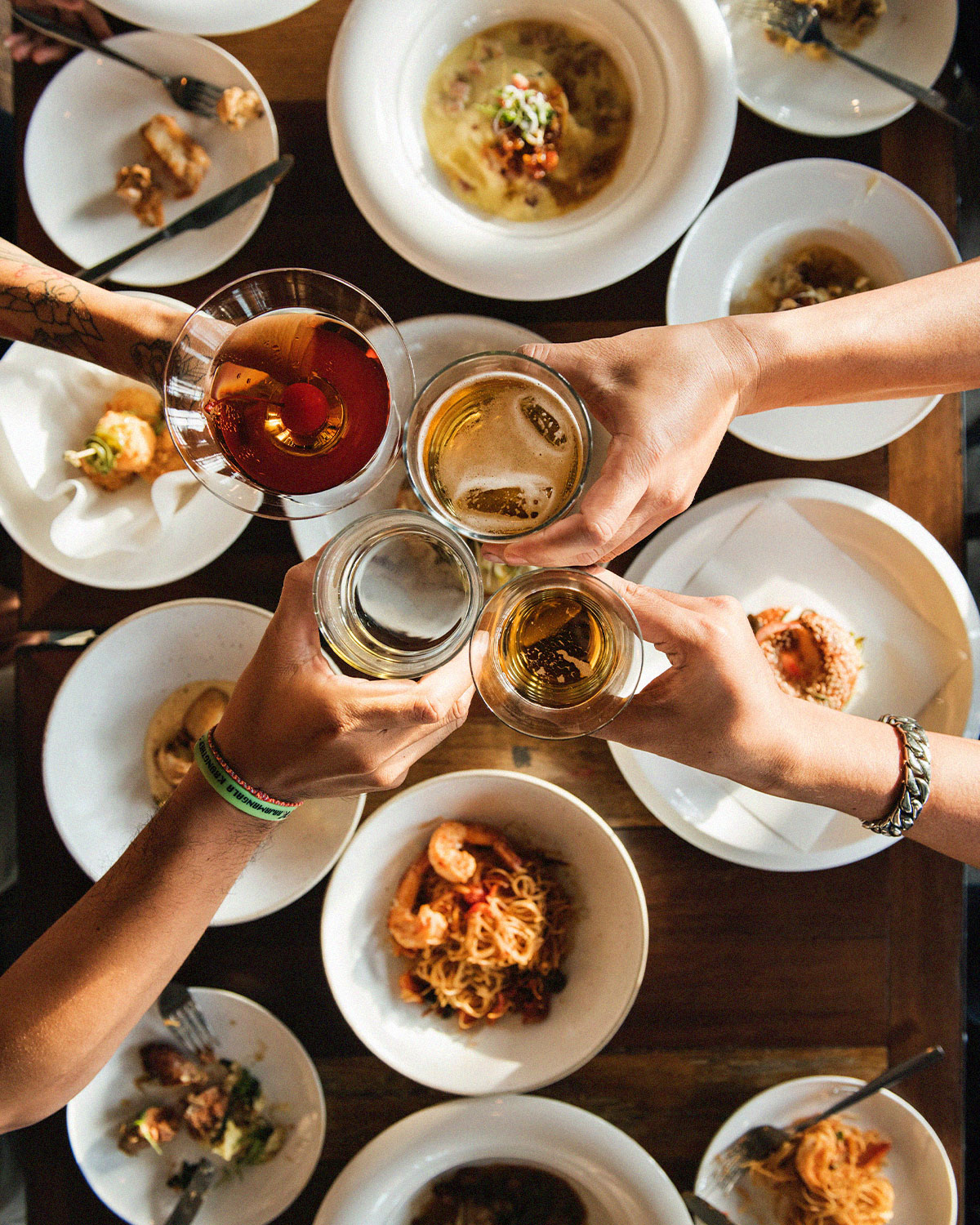 people cheering glasses over family dinner