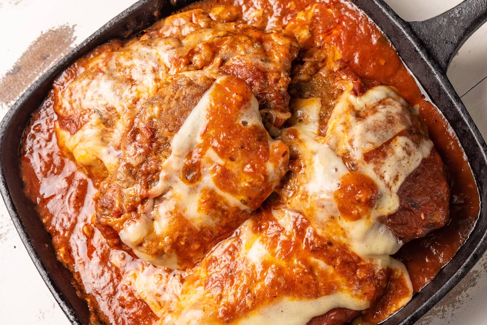 Chicken parmesan in cast iron pan, ready to serve