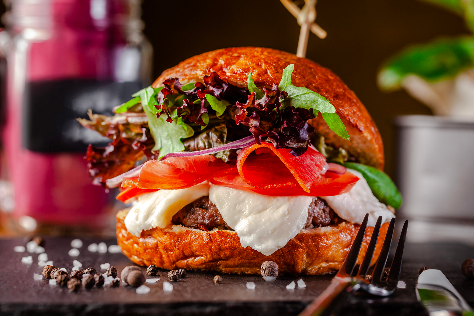 Hamburger with mozzarella and tomatoes on brioche bun