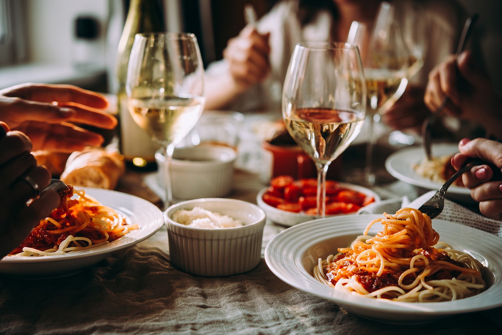 Italian Table Setting with people eating scrumptous pasta 